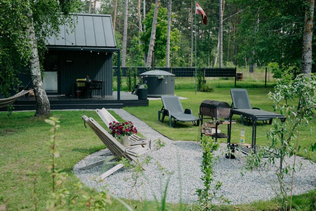 Landscaped garden and outdoor seating area beside a MyCabin modular home