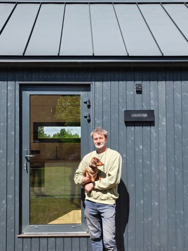 MyCabin homeowner with his dog outside their new home