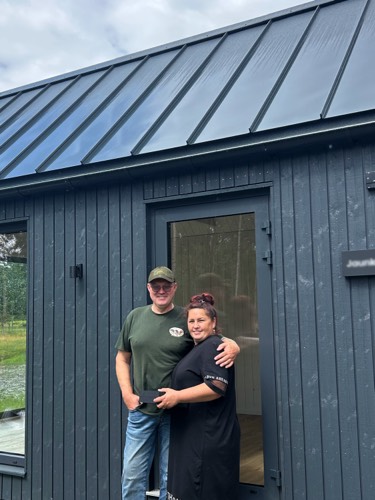 MyCabin homeowners outside their new home