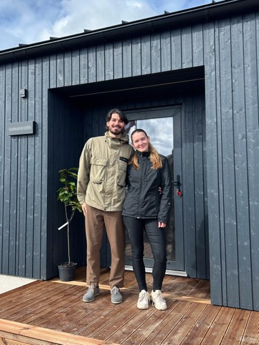 MyCabin homeowners on the deck of their new home