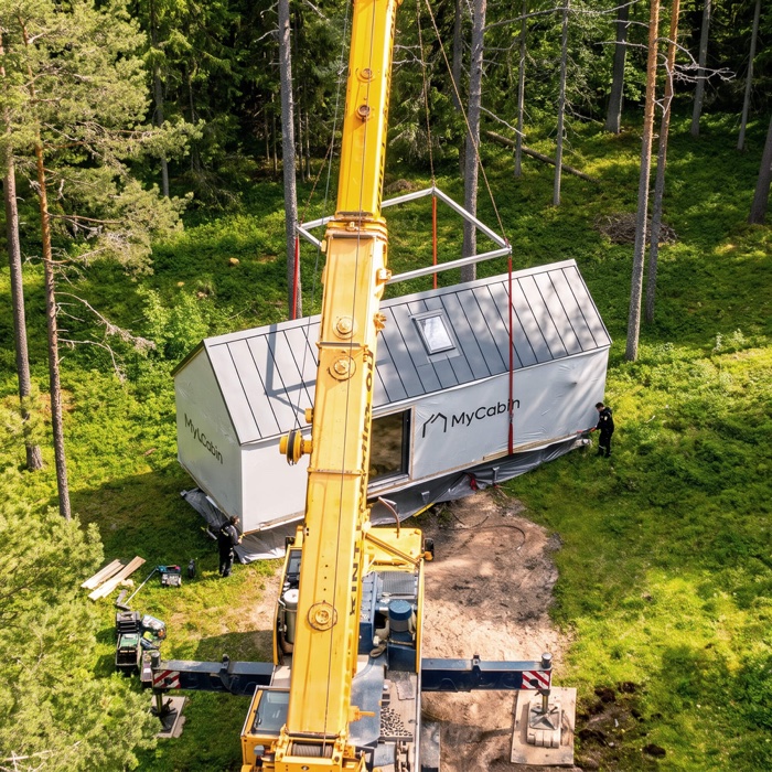 A MyCabin home being lifted into place by crane on site