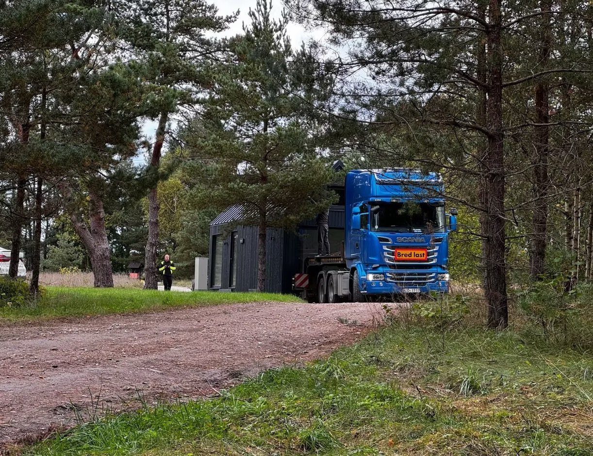A delivery truck bringing a MyCabin module from factory to foundation